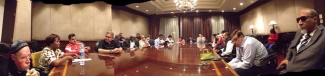 Members of the DPI World Council seated around tables in a meeting room.
